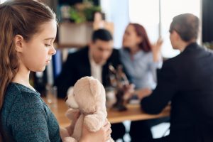 a child holding her teddy bear