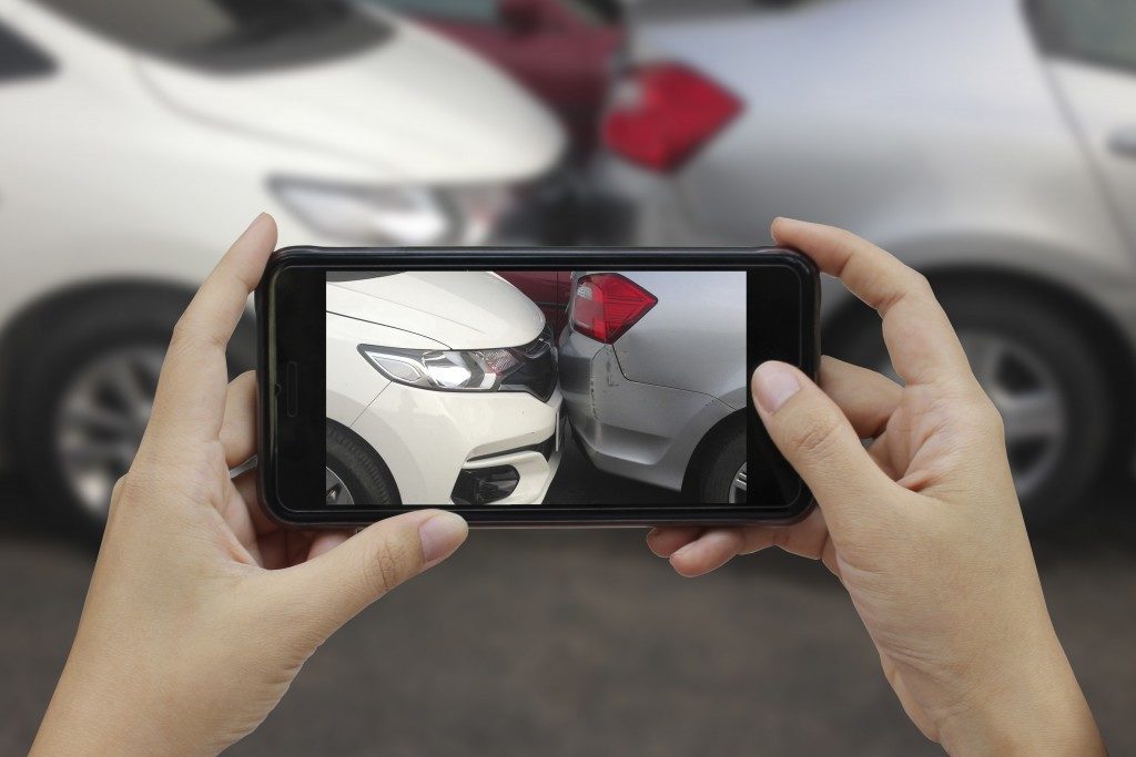 person taking a picture of crash