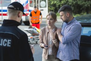 Couple talking to police after car accident