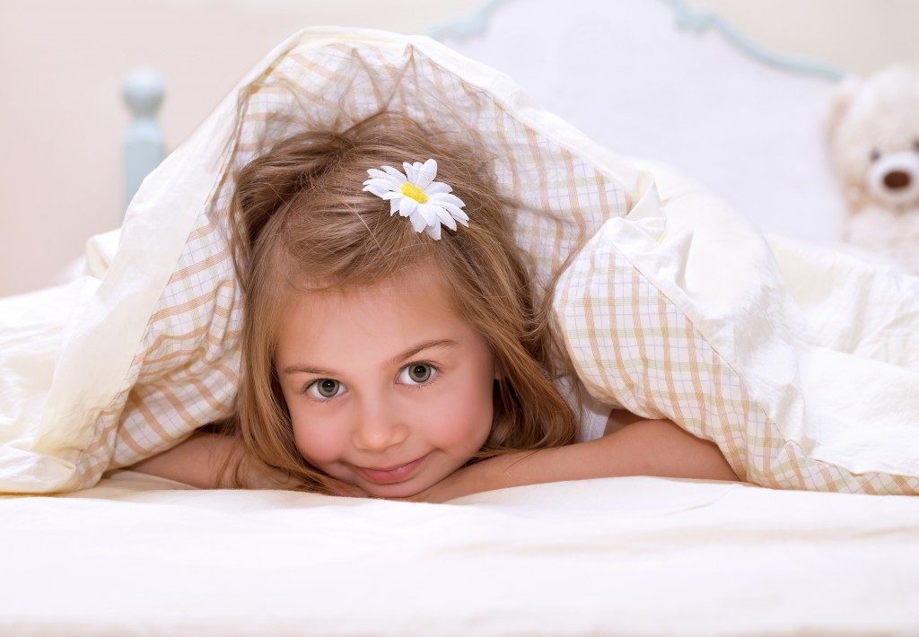 Little girl lying in bed