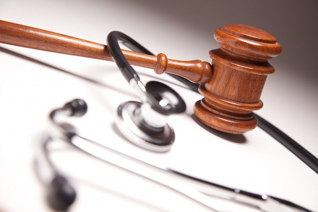 Gavel and Stethoscope on Gradated Background with Selective Focus