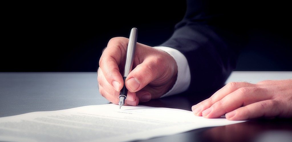 person signing a contract