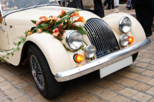 Vintage Wedding Car Decorated with Flowers.