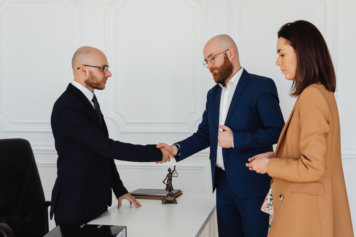 Men in Corporate Attire Shaking Hands at an Office