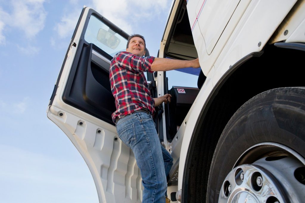 truck driver climbing into cab